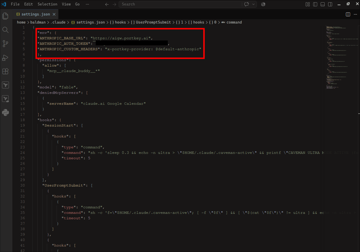 VS Code editing home slash .claude slash settings.json with the env block highlighted at the top containing ANTHROPIC_BASE_URL set to https://aigw.portkey.ai, a redacted ANTHROPIC_AUTH_TOKEN, and ANTHROPIC_CUSTOM_HEADERS set to x-portkey-provider at default-anthropic, with the user's existing settings continuing below